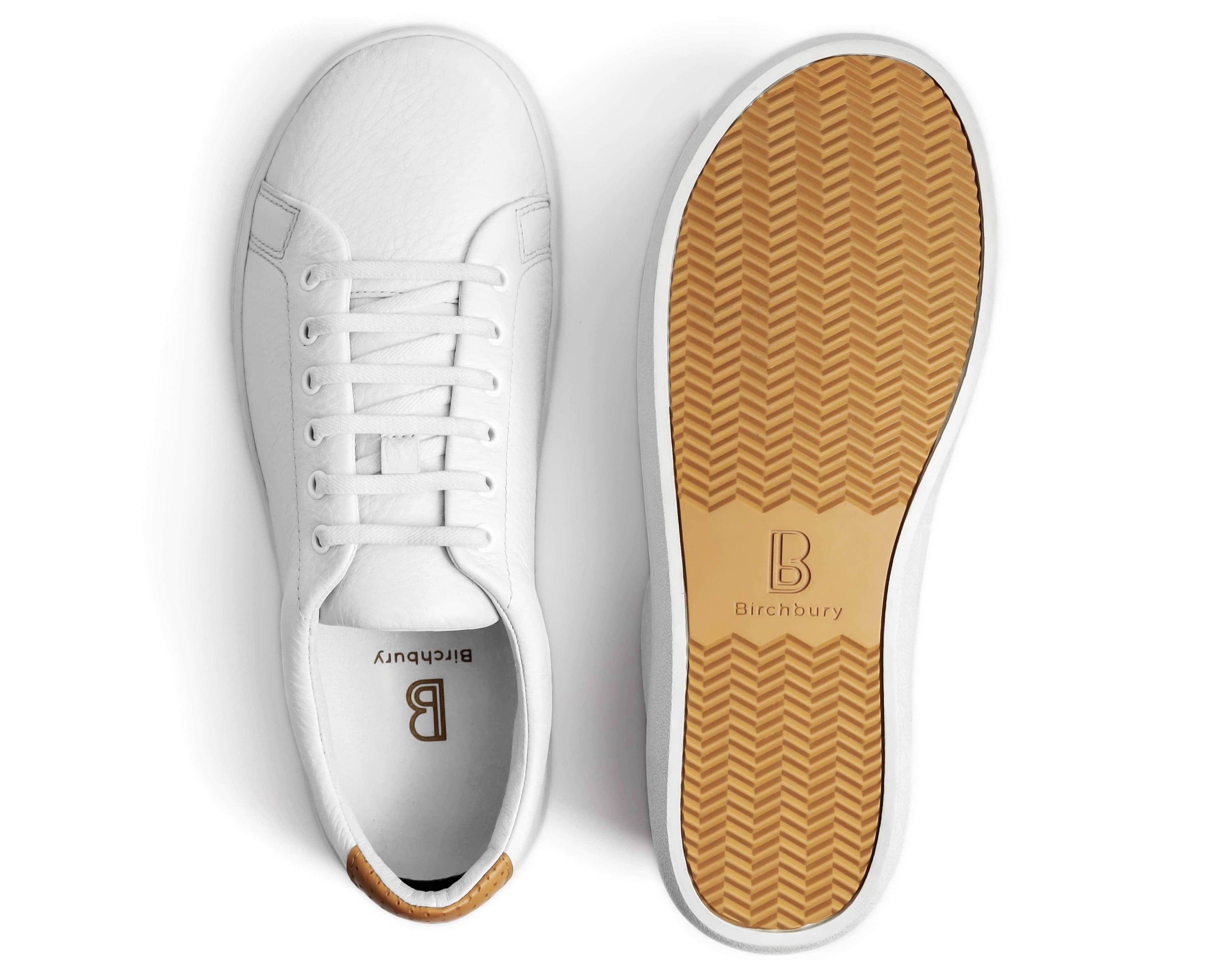 Person wearing black sneakers and beige pants outdoors.